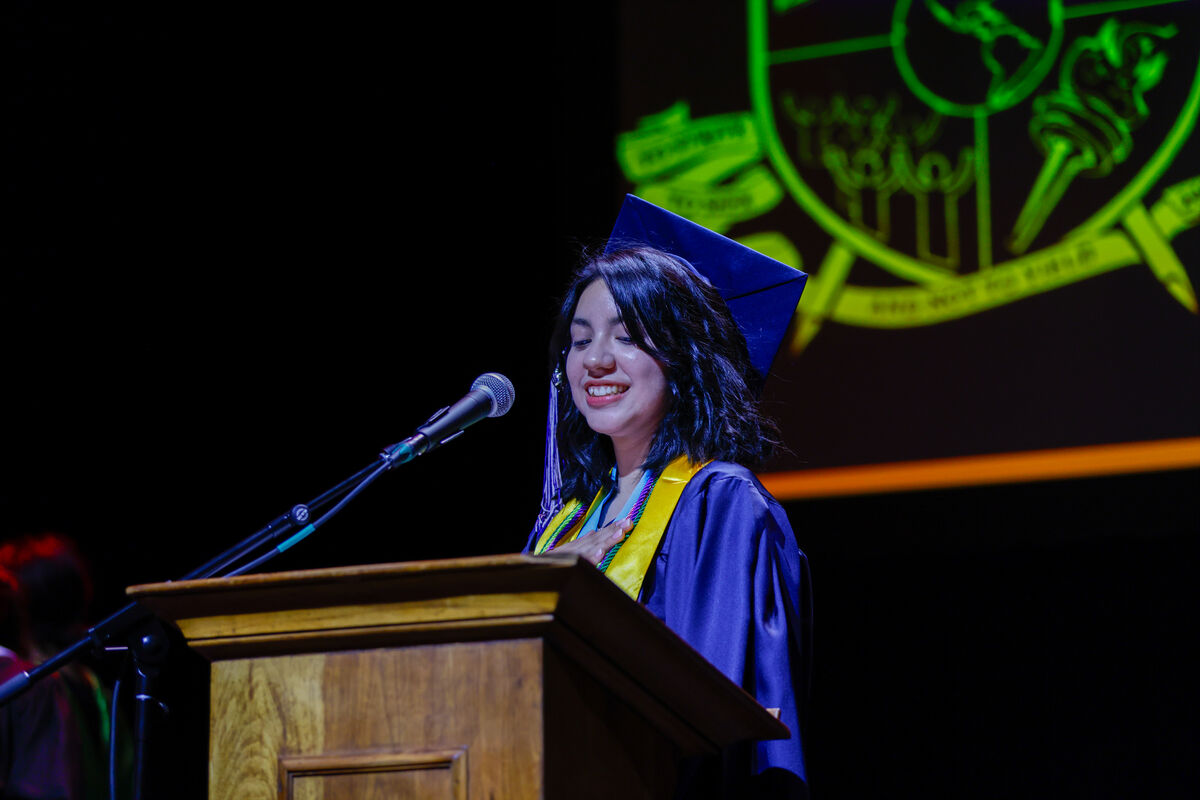 Value Schools graduation ceremony with student speaking at podium